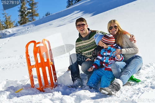 Image of family having fun on fresh snow at winter vacation