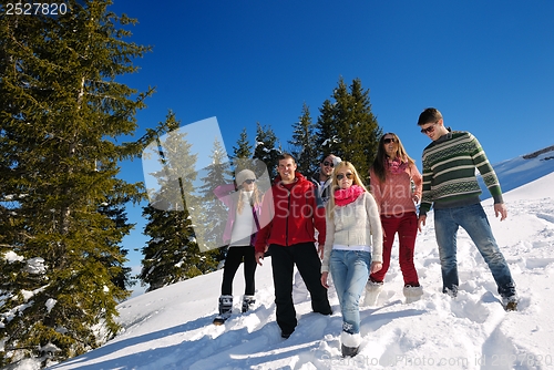 Image of friends have fun at winter on fresh snow