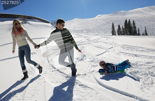 Image of family having fun on fresh snow at winter vacation