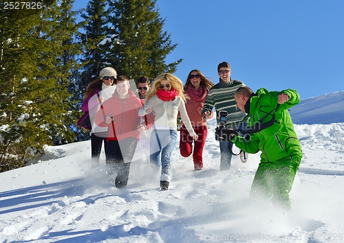 Image of friends have fun at winter on fresh snow