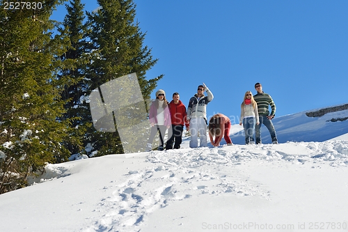 Image of friends have fun at winter on fresh snow