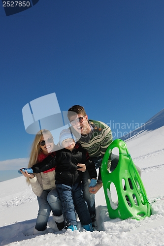 Image of family having fun on fresh snow at winter vacation