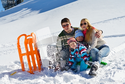 Image of family having fun on fresh snow at winter vacation