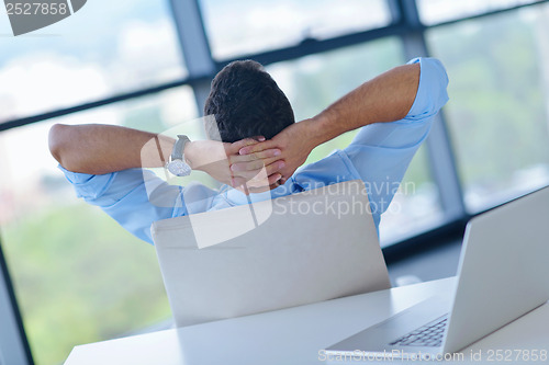 Image of happy young business man at office
