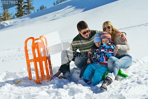 Image of family having fun on fresh snow at winter vacation