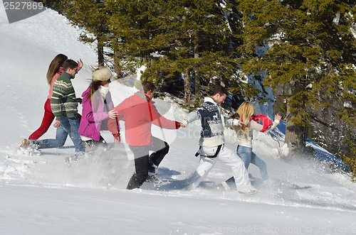 Image of friends have fun at winter on fresh snow