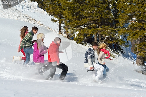 Image of friends have fun at winter on fresh snow