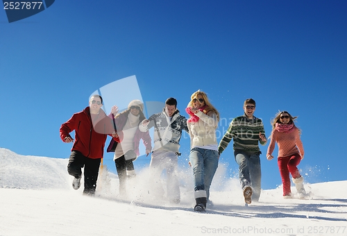Image of friends have fun at winter on fresh snow