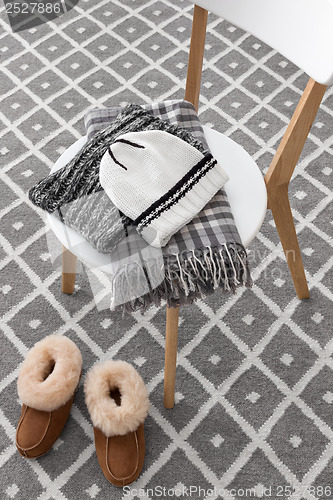 Image of Warm winter clothes on a chair