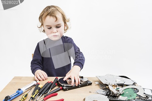 Image of child repairing computer part