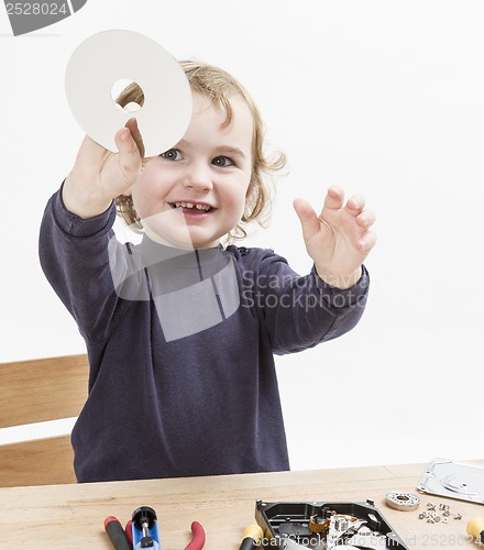 Image of child repairing computer part