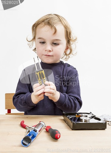 Image of child choosing tool for repairing hard drive