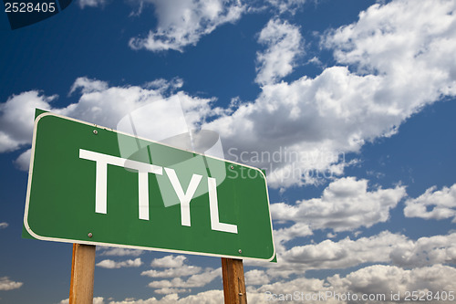 Image of TTYL Green Road Sign Over Sky