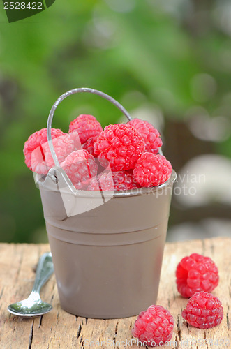 Image of raspberry on wooden background