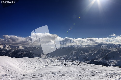 Image of Ski slope and blue sky with sun rays
