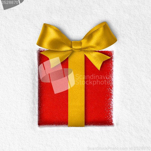 Image of gift with a bow on snow background