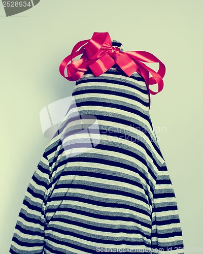 Image of striped dress with a bow on her head