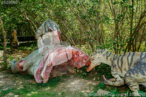 Image of model of two raptors eating pray