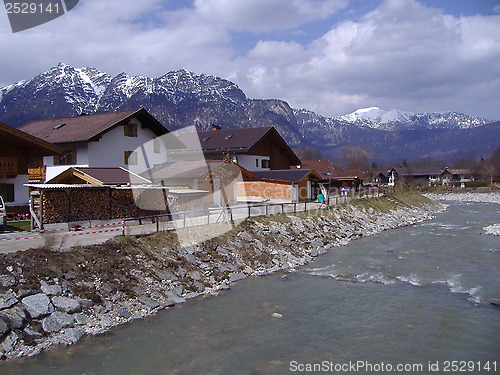 Image of Alpine cottages by a river