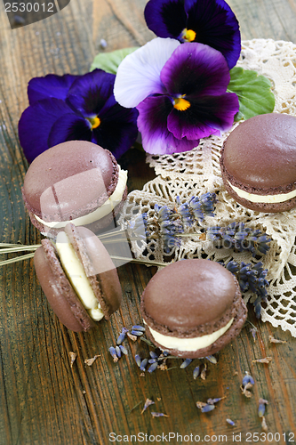 Image of Macarons and flowers violets. 