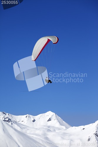 Image of Paraglider in snowy winter mountains