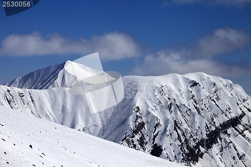 Image of Off-piste slope with stones and mountains with trace of avalanch