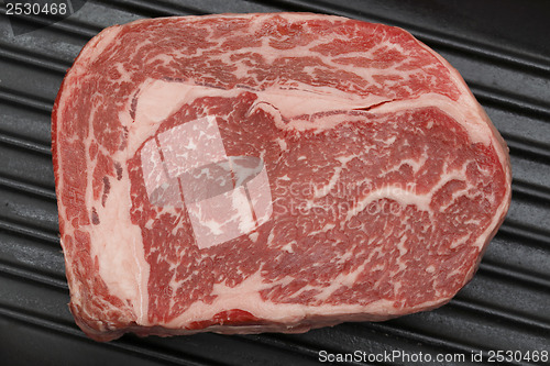 Image of Wagyu beef steak in a pan from above