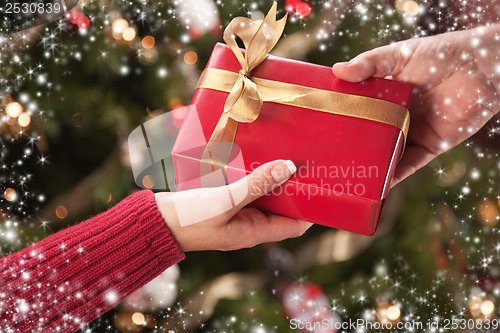 Image of Man and Woman Gift Exchange with Snow Flakes Border