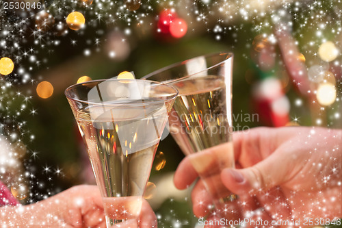 Image of Man and Woman Toasting Champagne in Front of Lights