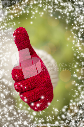 Image of Woman Wearing Red Mittens Holding Out Thumbs Up Hand Sign