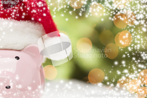 Image of Pink Piggy Bank with Santa Hat on Snowflakes