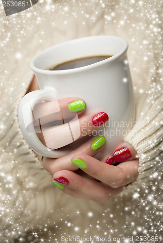 Image of Woman with Red and Green Nail Polish Holding Cup of Coffee