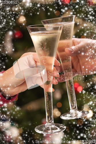 Image of Man and Woman Toasting Champagne in Front of Lights