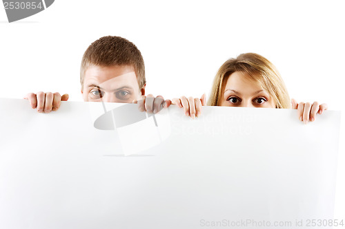 Image of couple peeking out from behind the booth