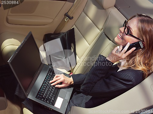 Image of businesswoman has a fan with laptop