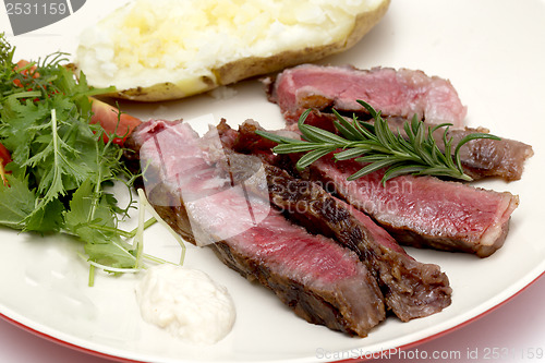 Image of Wagyu beef sliced with salad and potato