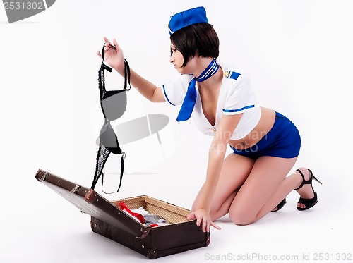 Image of Young beautiful air hostess  with suitcase