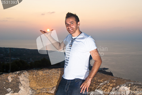 Image of handsome man at sunset