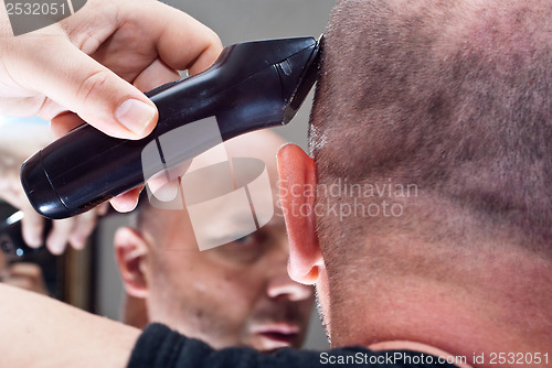 Image of Man in the mirror cuts her hair