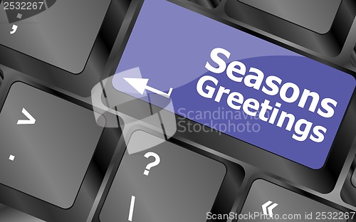 Image of Computer keyboard with seasons greetings keys - holiday concept