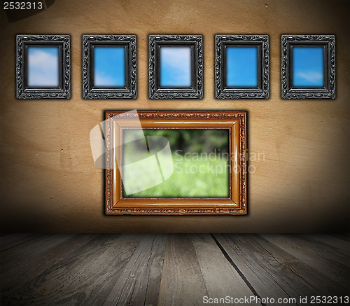 Image of ancient wooden frames on grunge wall
