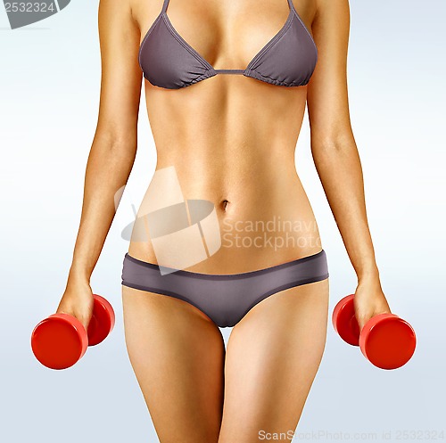 Image of body of woman with dumbbells