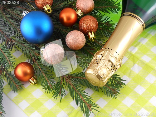 Image of champagne bottle and christmas baubles, Merry Christmas and Happy New Year