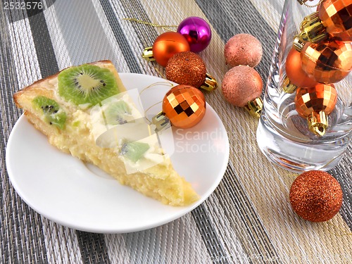 Image of kiwi tasty cake with champagne wine bottle and christmas balls