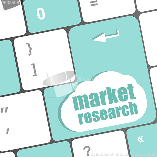 Image of key with market research text on laptop keyboard