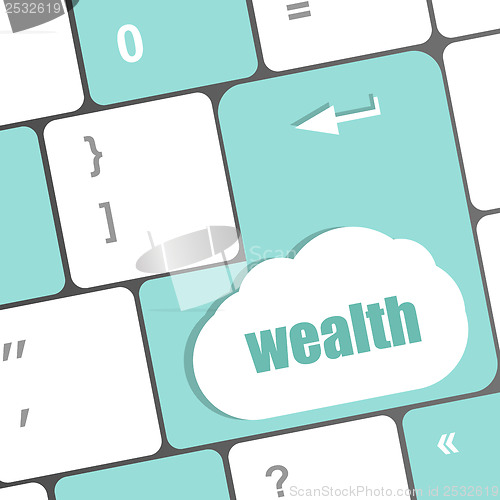 Image of cloud icon with wealth word on computer keyboard key