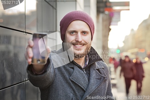 Image of Young man with smartphone