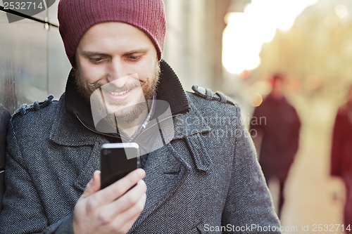 Image of Young man with smartphone