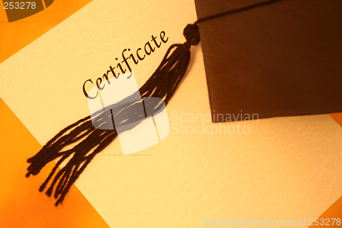 Image of certificate and graduation cap, top view