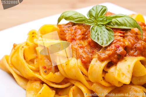 Image of Pasta decorated with basil leaves